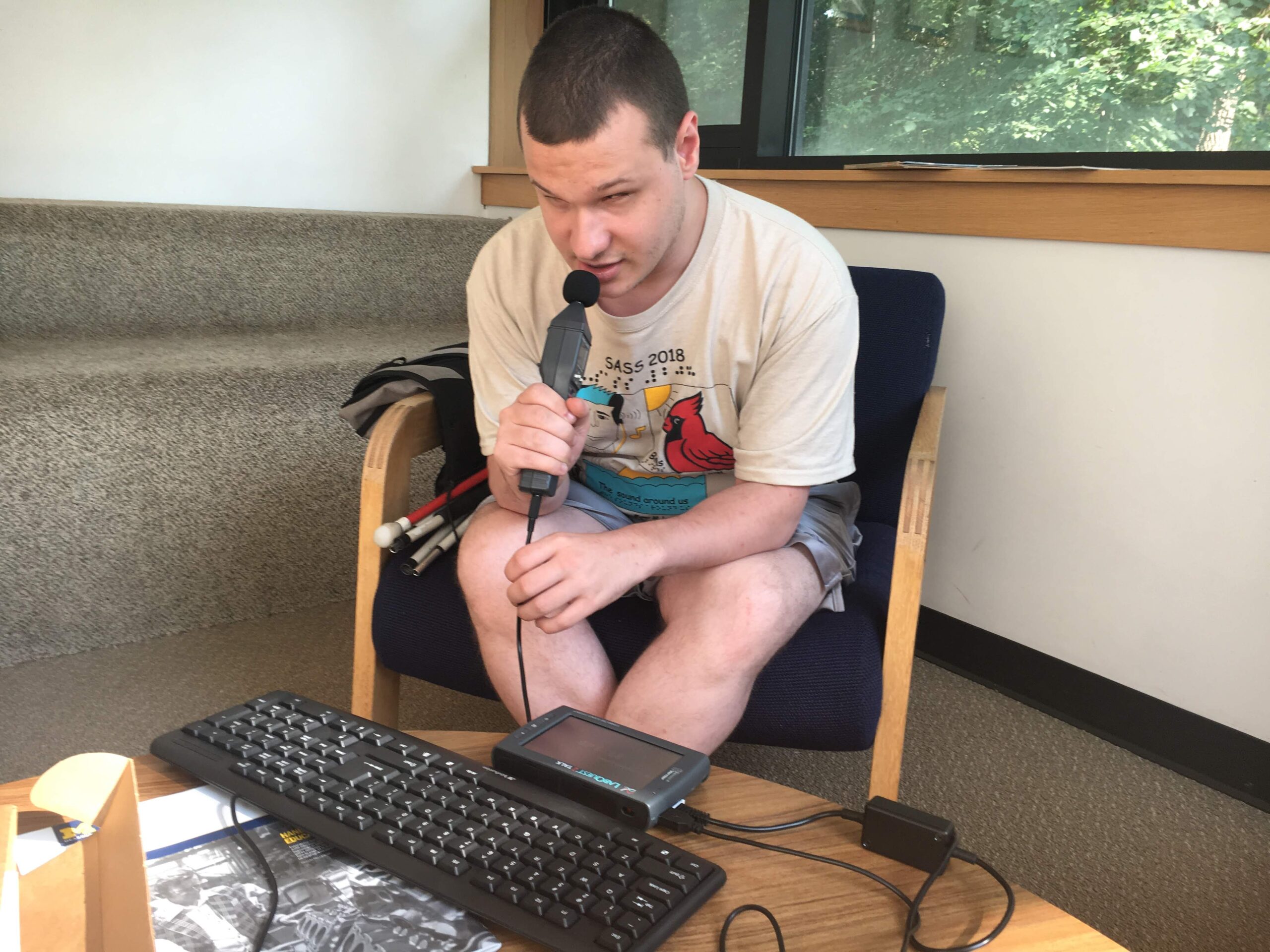 A student using the microphone sensor to see how many decibels his voice is