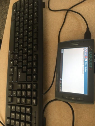 8. Picture of TLQ and keyboard. TLQ is on notes page and reads "The sounds of science is awesome"