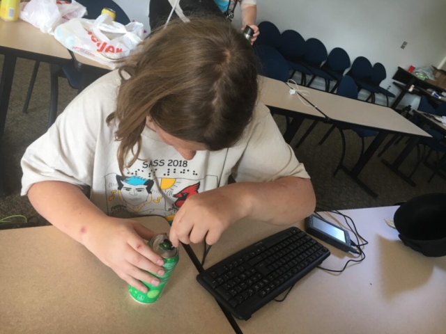A student checking the temperature of a fizzy drink using LabQuest
