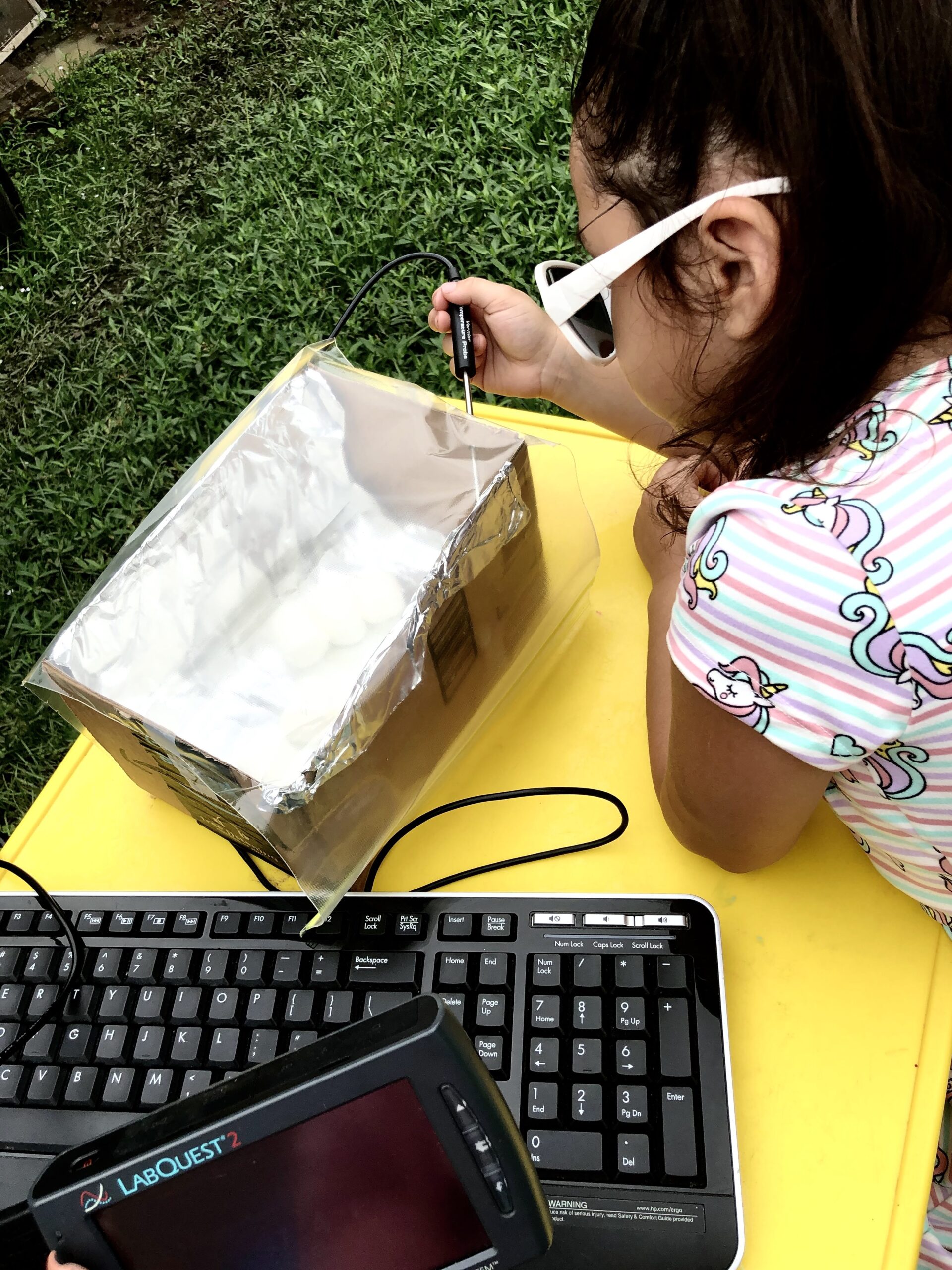 Student using Talking LabQuest to roast marshmallows in a homemade solar oven