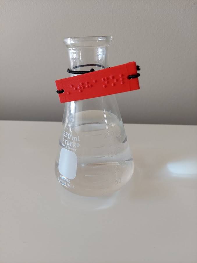conical flask with Braille Mark braille label "Ethanol" attached