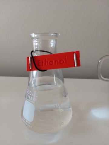 conical flask with attached Braille Mark label "Ethanol" in engraved text